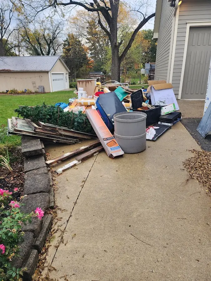 Dumpster being loaded with debris for Estate Cleanout Dumpster Rental in Lansdowne